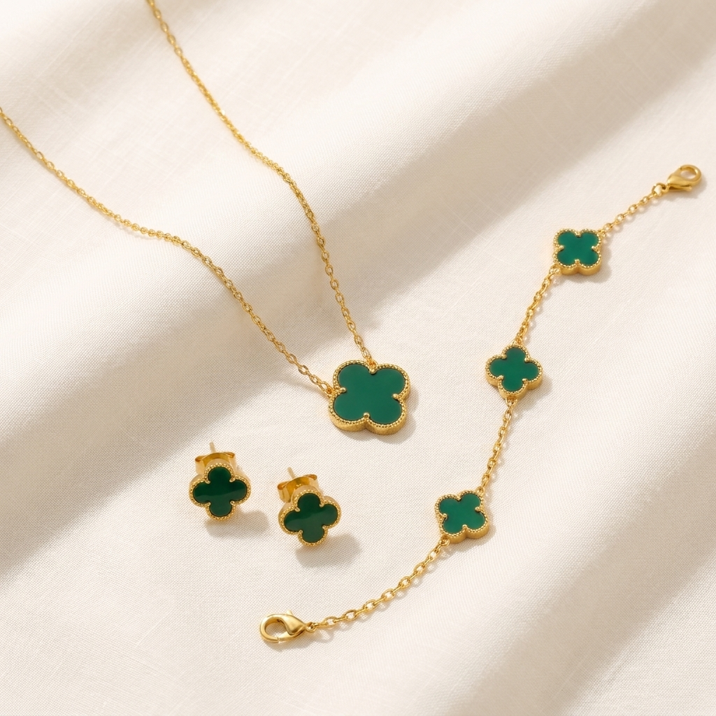 The Clover Set — flat lay of necklace, bracelet and studs